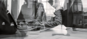 Black and white image of business people in a meeting room